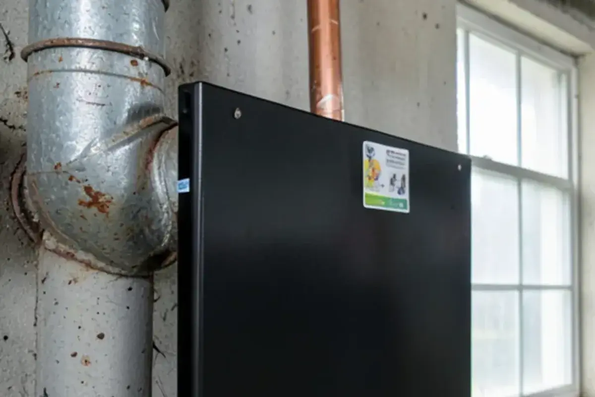 Refrigerator magnet stuck to a galvanized steel water pipe in a basement