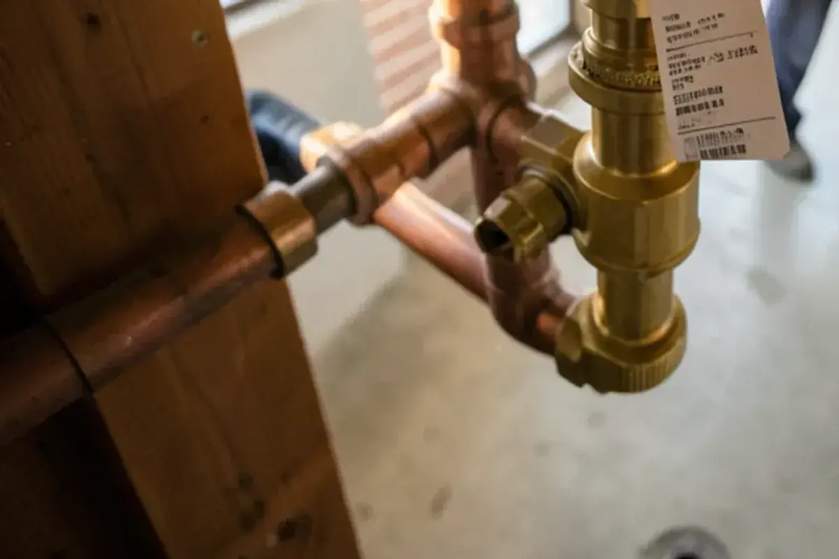 RPZ backflow assembly with a dated test tag on the domestic water line of a commercial building